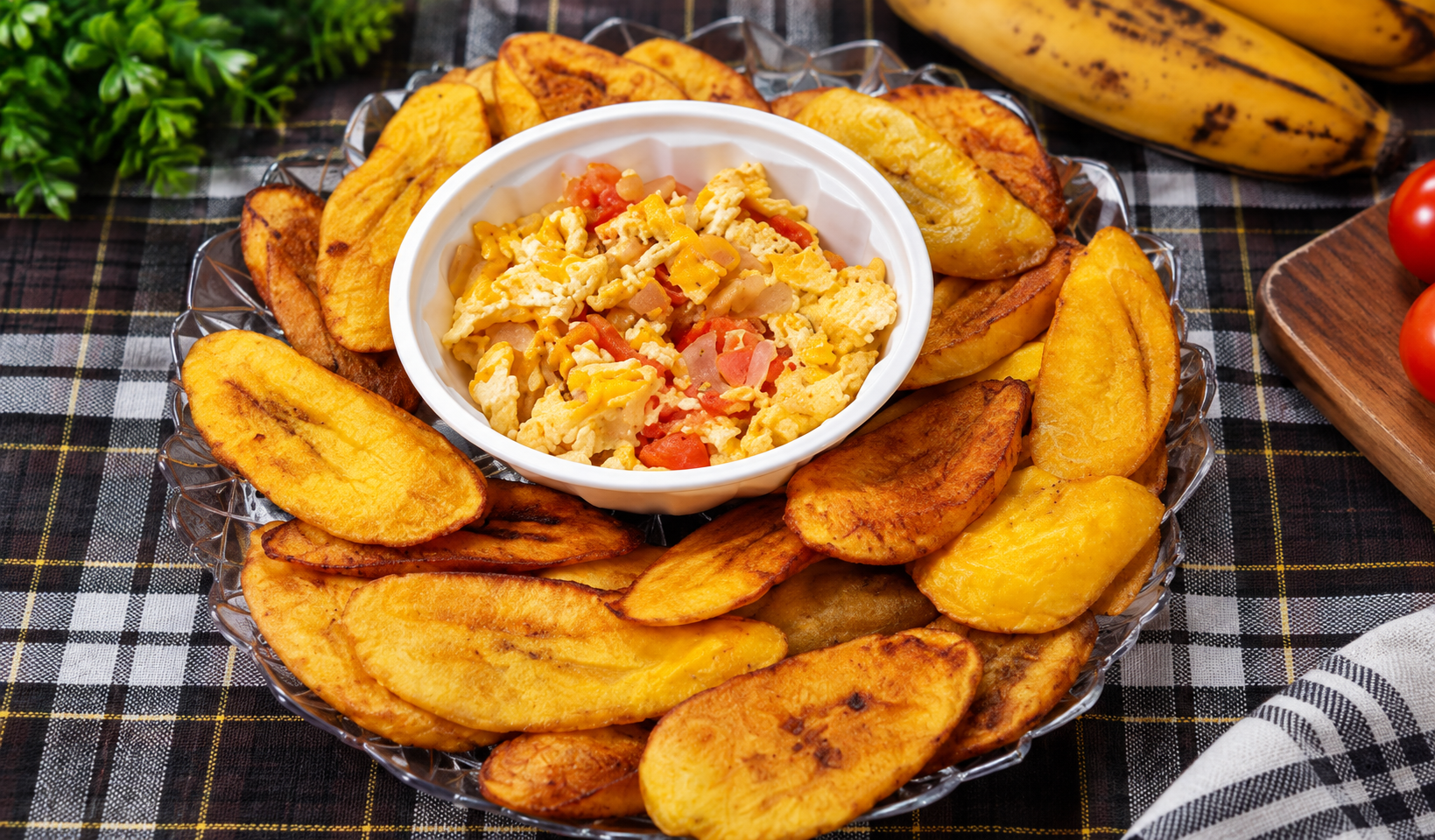 Fried plantain slices arranged around a bowl of Nigerian egg sauce